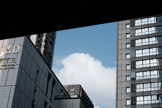 Modern aluminum window frames installed on a high-rise building reflecting the blue sky.