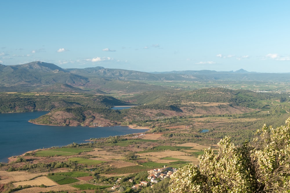 a scenic view of a lake surrounded by mountains