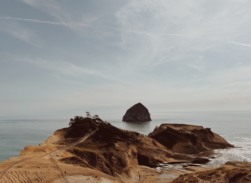 a rock outcropping in the middle of the ocean