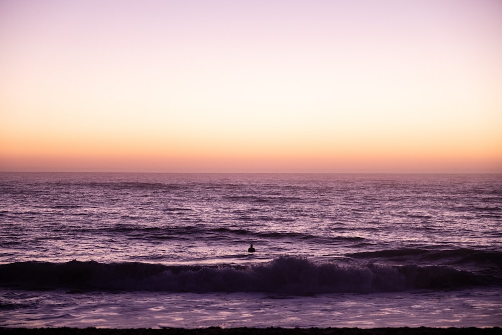 a person riding a surfboard on a wave in the ocean