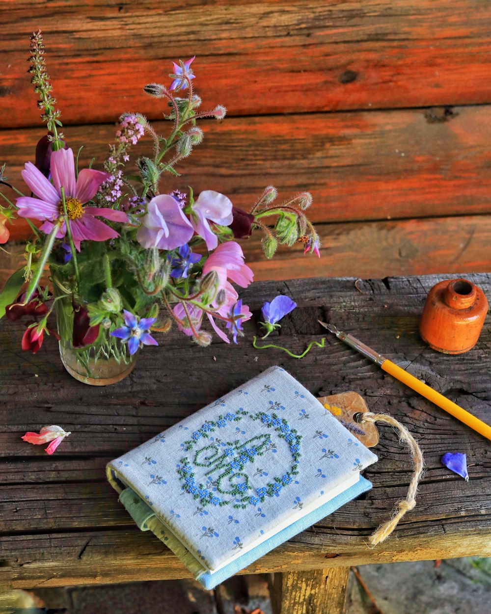 a vase of flowers sitting on top of a wooden table