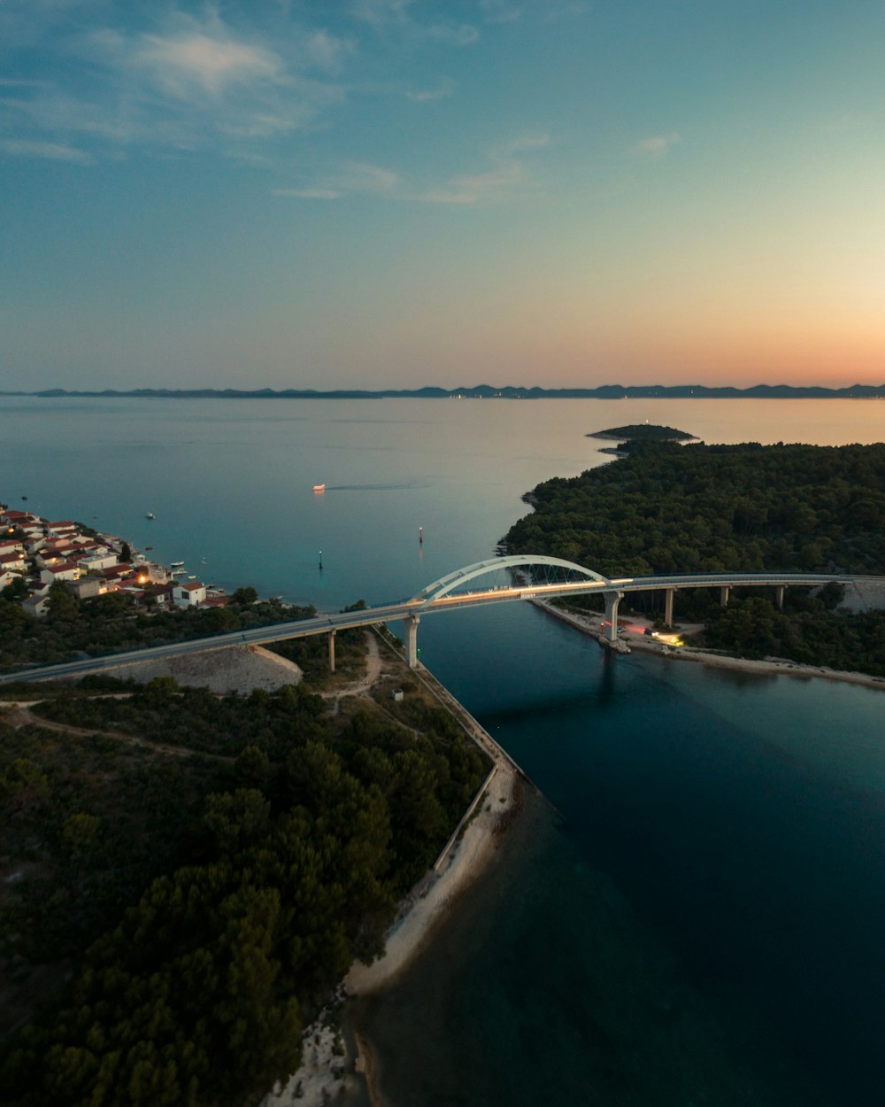 an aerial view of a bridge over a body of water