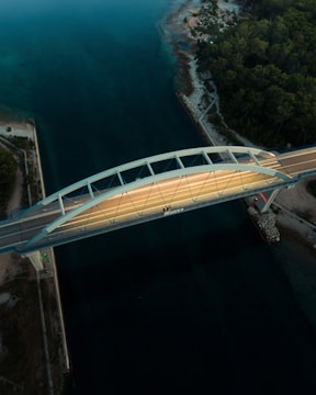 Aerial view of a modern bridge spanning over a river.