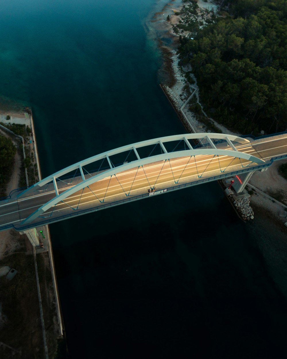 an aerial view of a bridge over a body of water