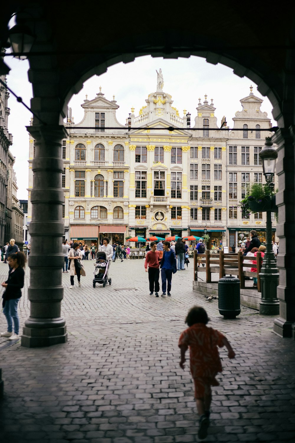 a small child is walking through an archway