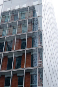 Modern commercial office space with glass facade and Jaipur-inspired decorative elements.