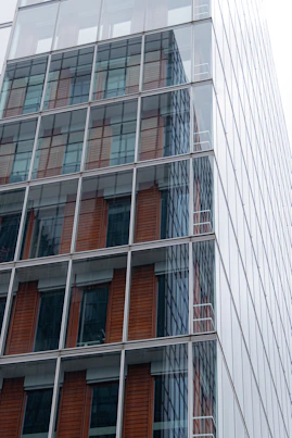 Glass facade of a modern commercial building with clean lines.