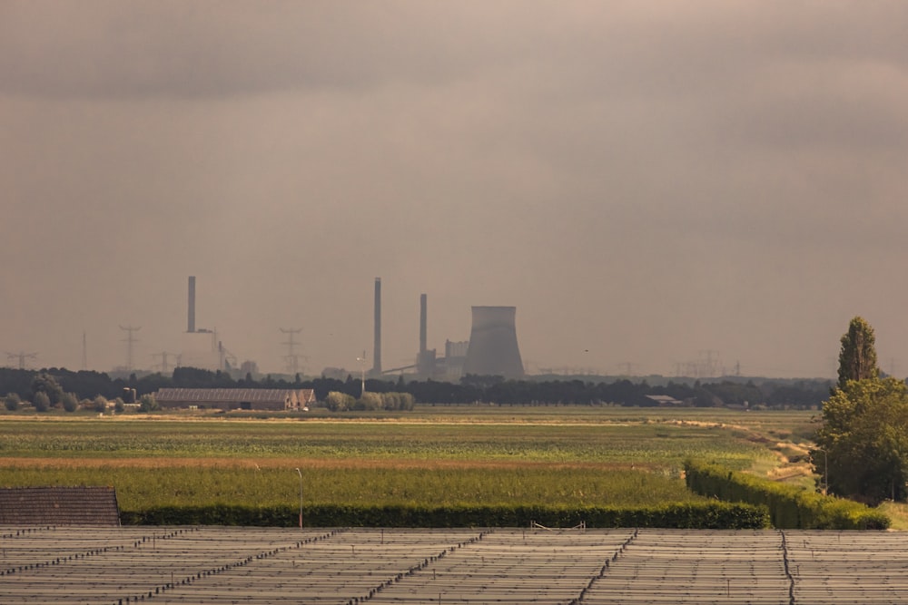 a factory with a large amount of smoke in the distance