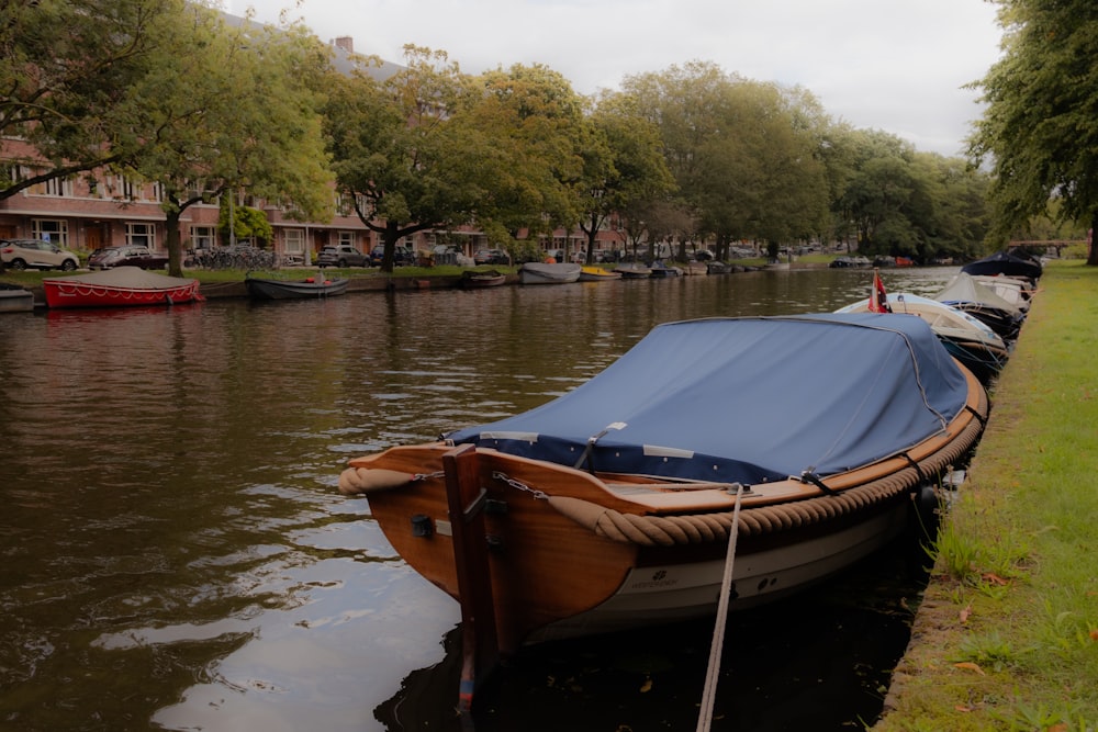 a row of boats sitting on top of a river