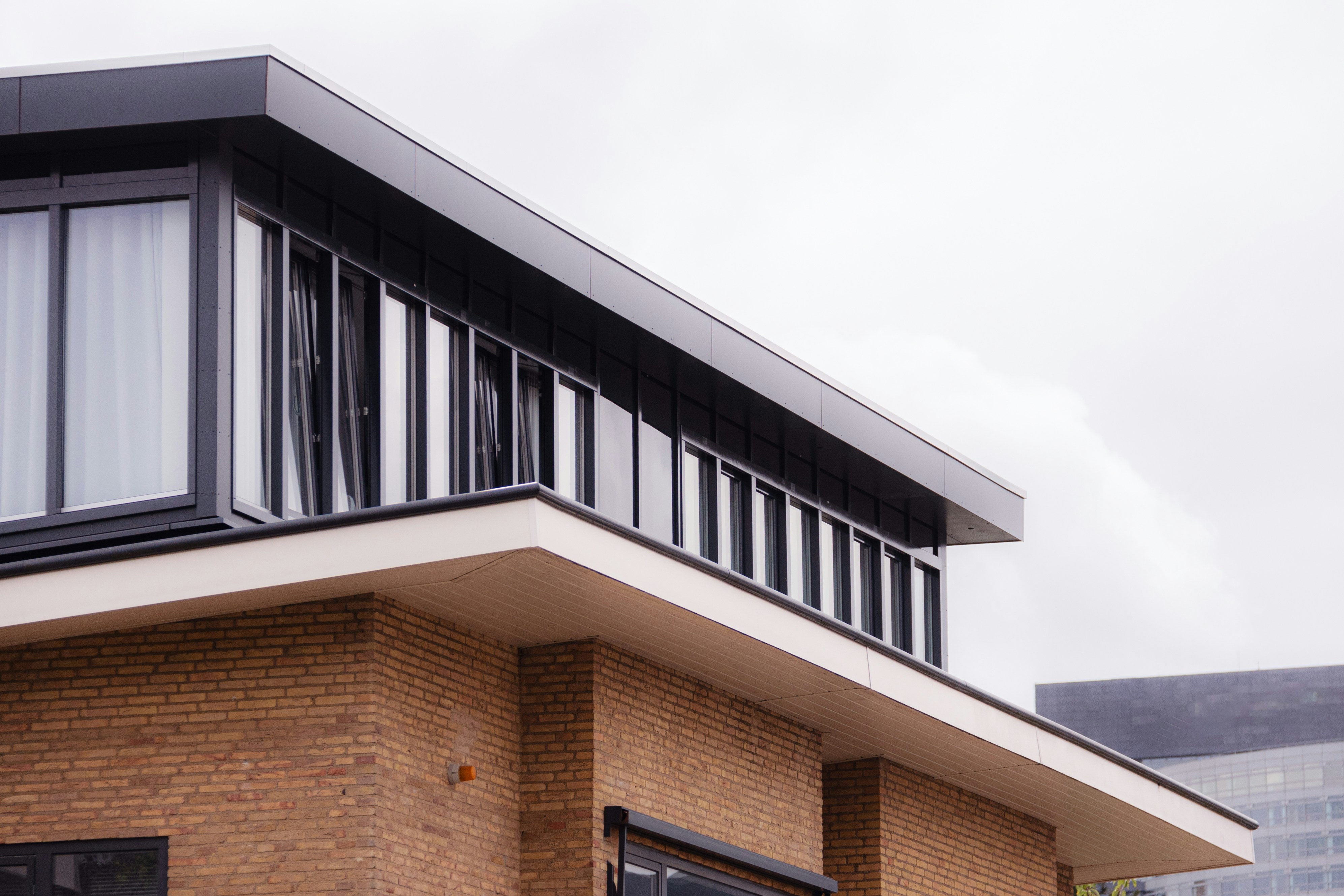 a brick building with a black metal balcony