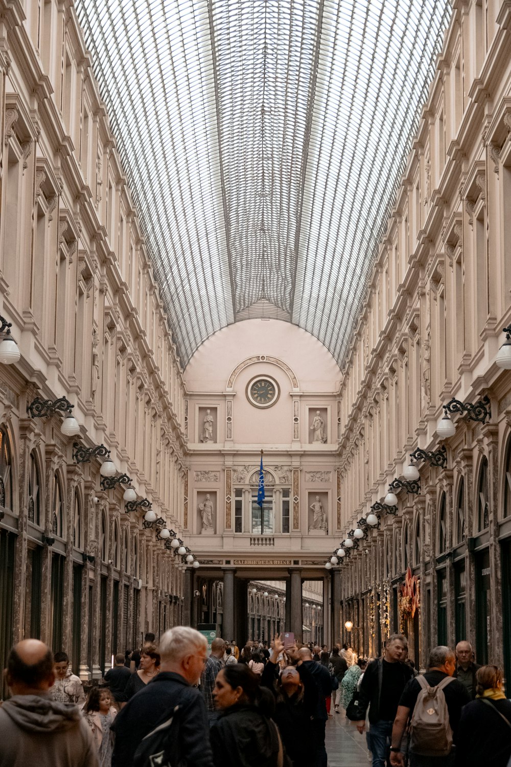 a group of people walking down a long hallway