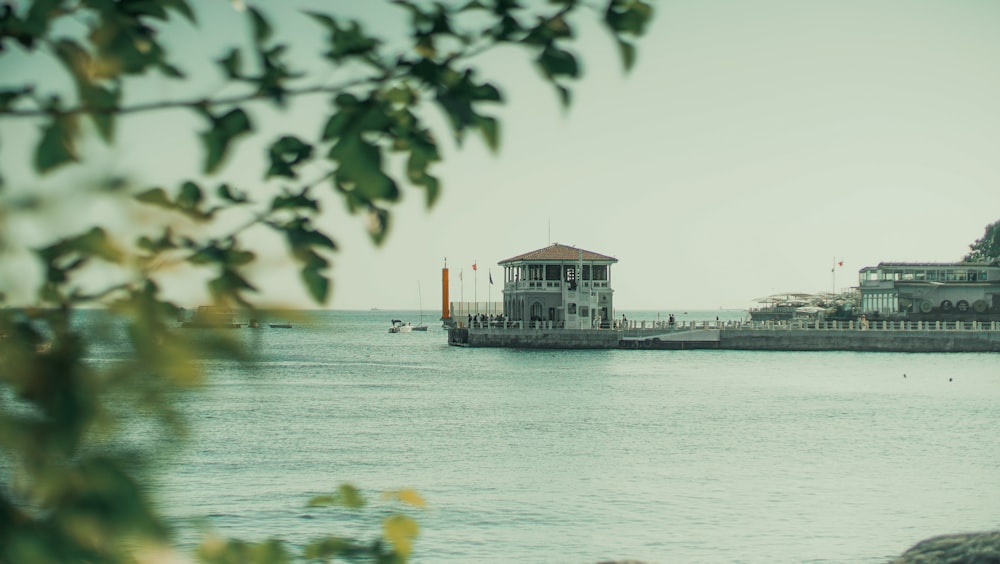 a large body of water with a building in the background