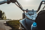 A close-up of a motorbike dashboard with the Alps towering in the background.