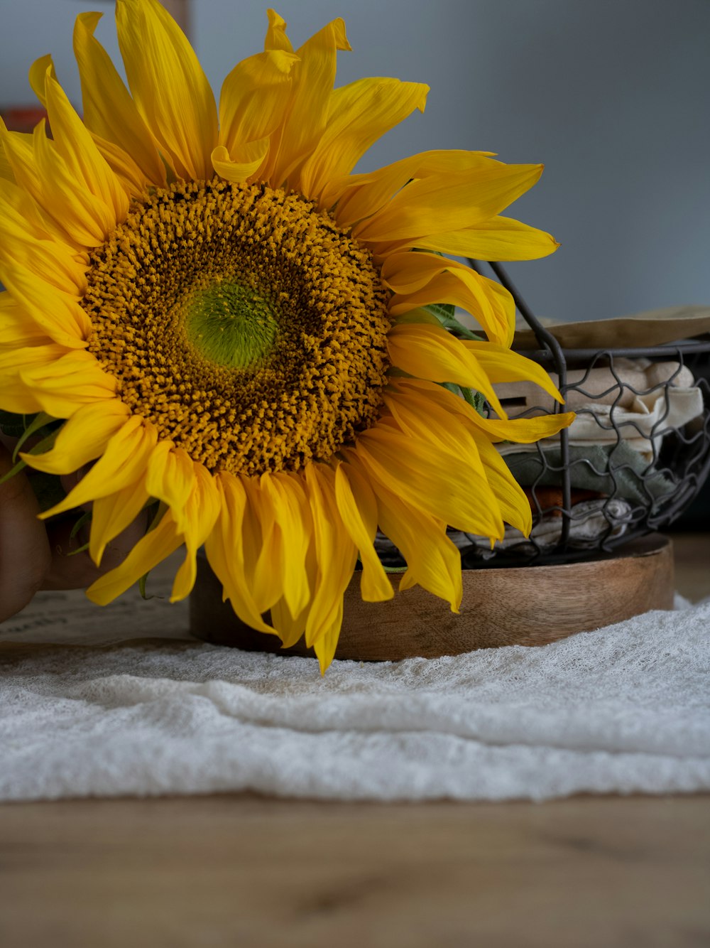 a large sunflower sitting on top of a wooden table