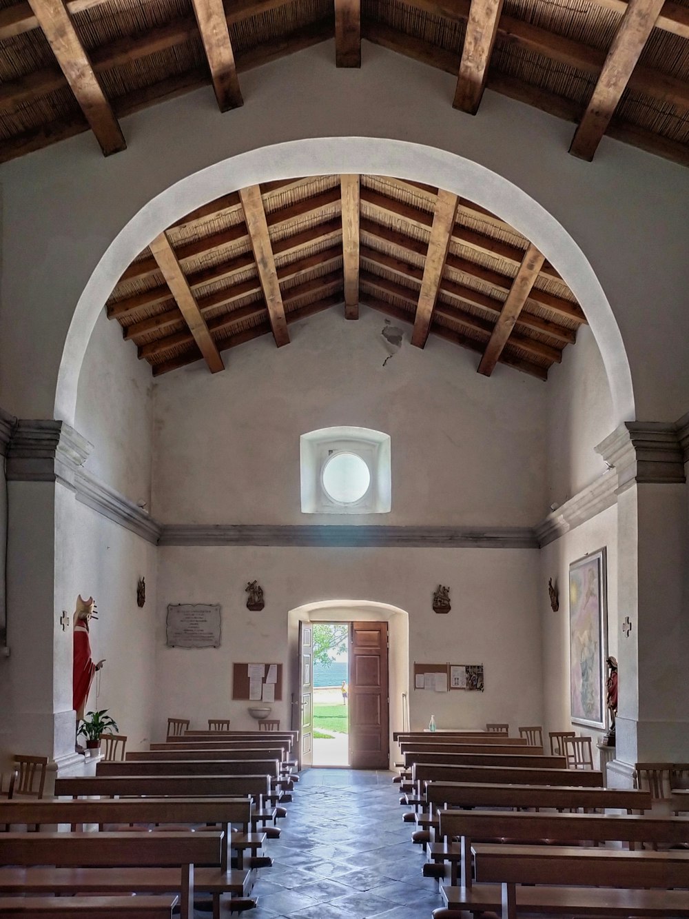 the inside of a church with wooden pews