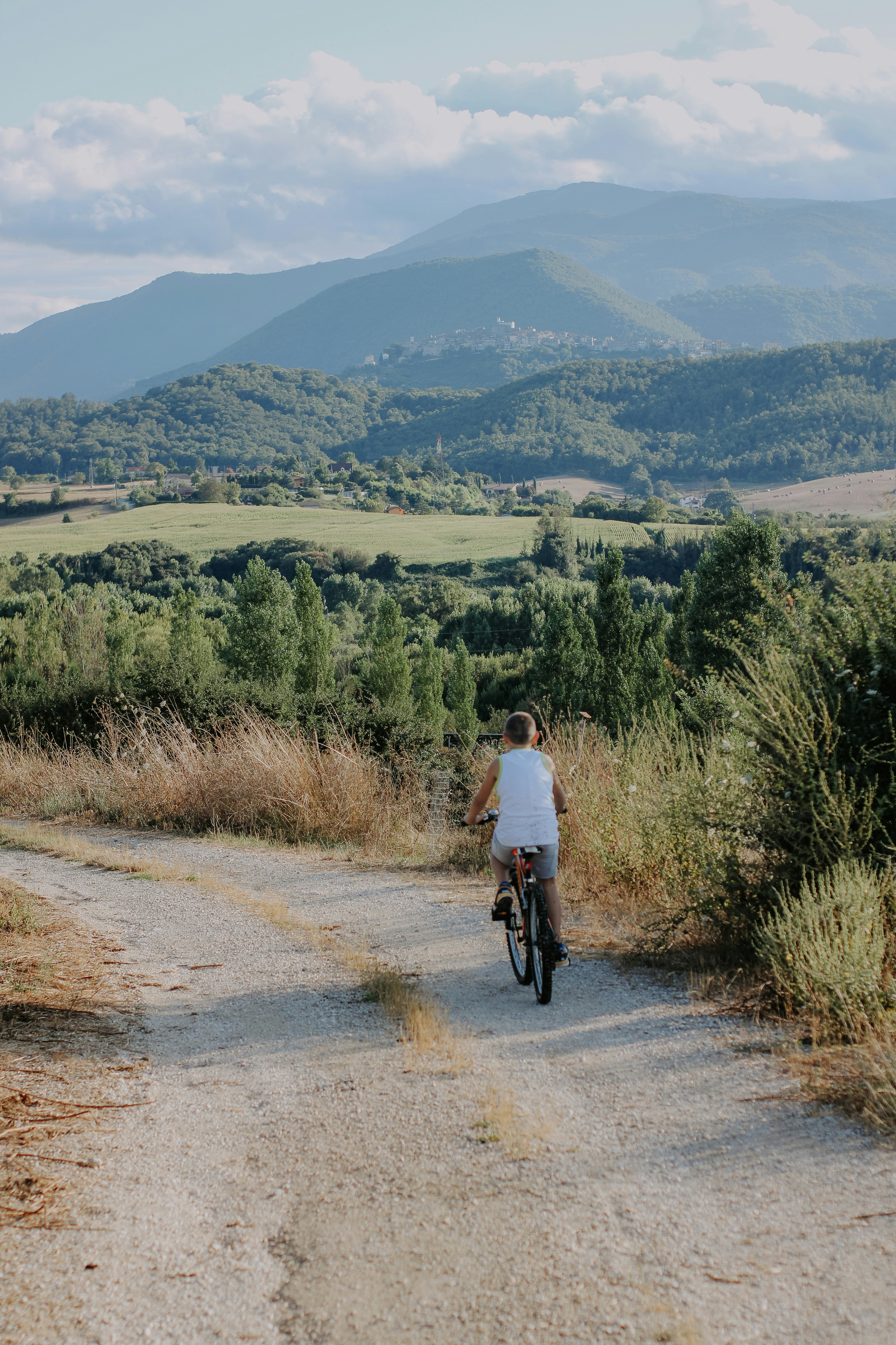 a person riding a bike down a dirt road