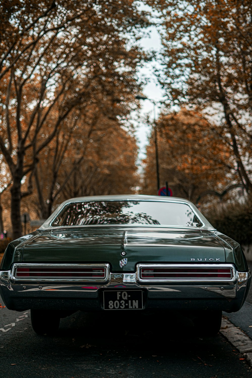 a green car parked on the side of the road