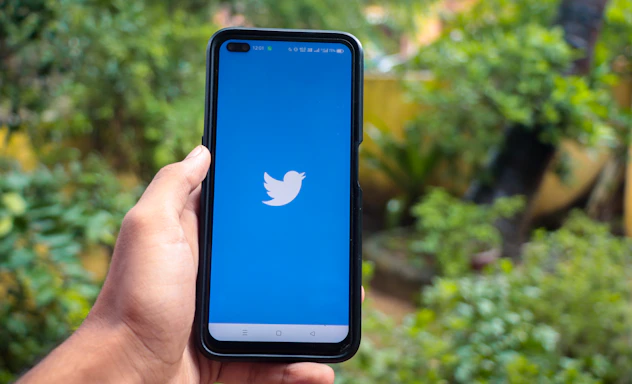 A sleek, modern illustration of a smartphone displaying a message notification in Twitter blue.