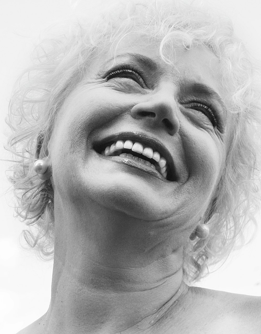 a black and white photo of a woman smiling