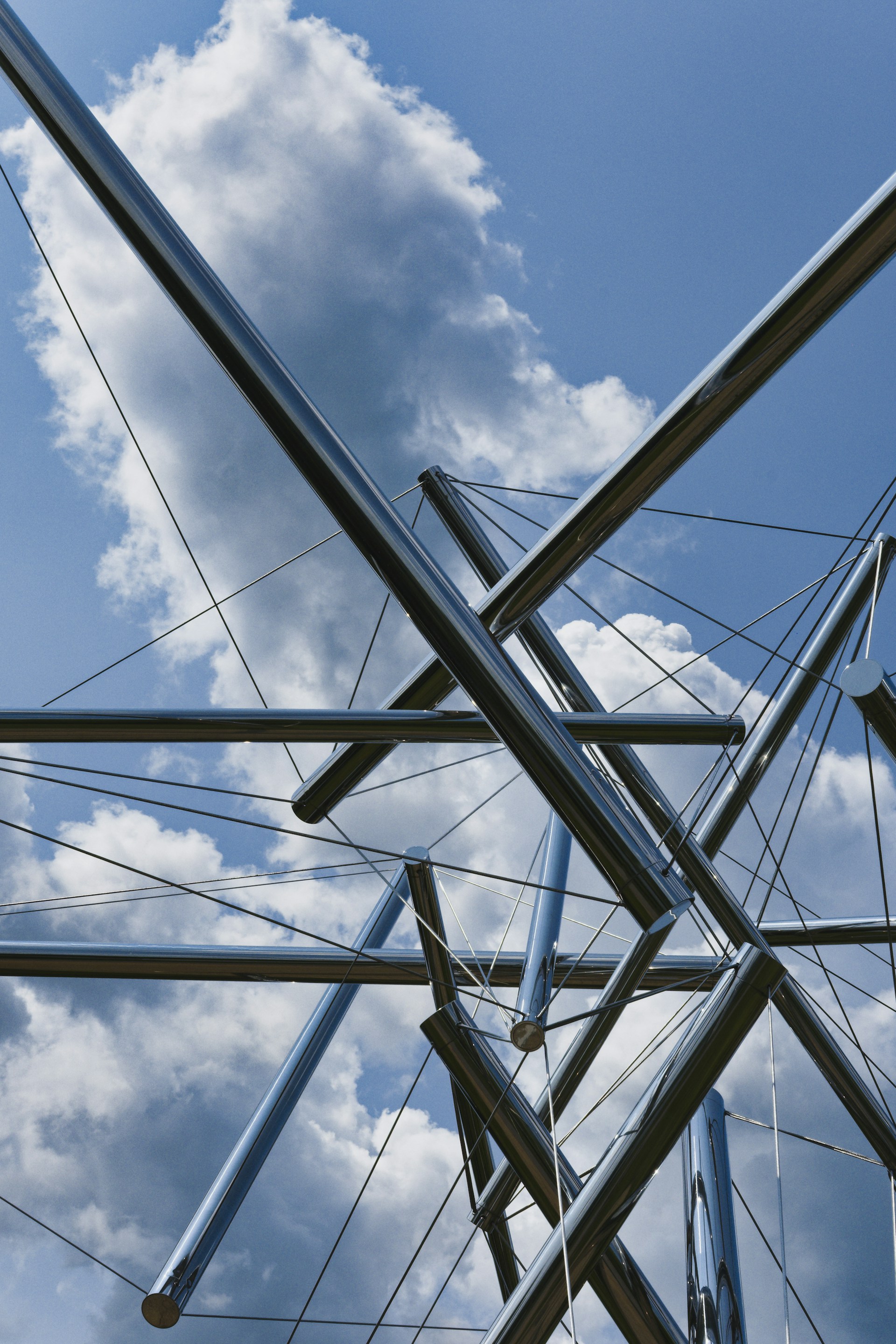 a group of metal poles against a cloudy blue sky