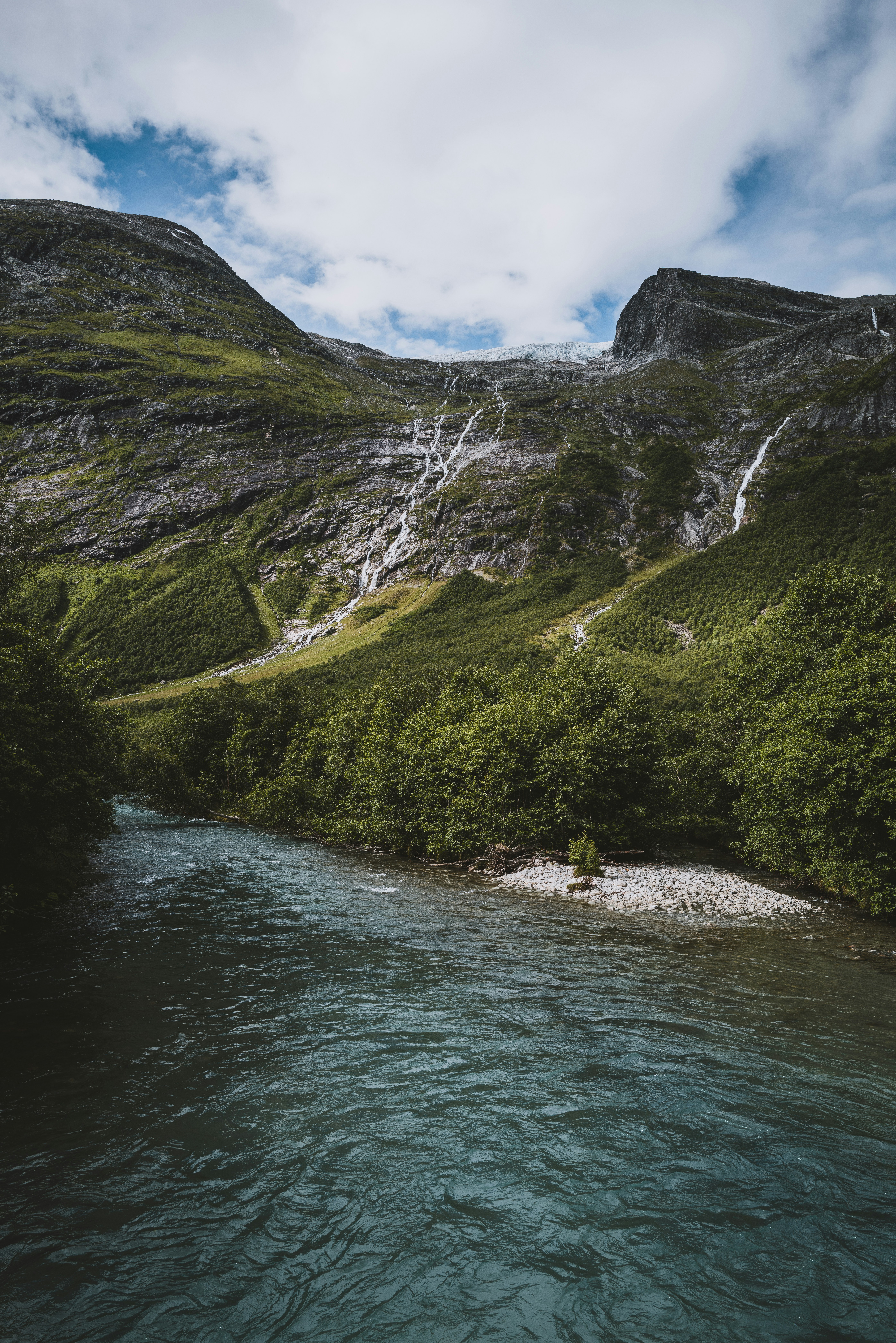 a river running through a lush green valley