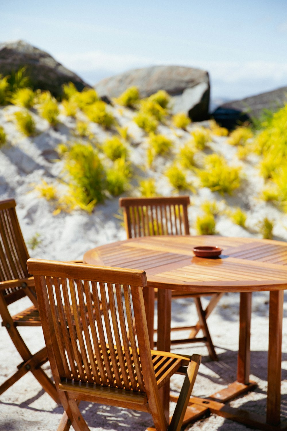 a wooden table with four chairs around it