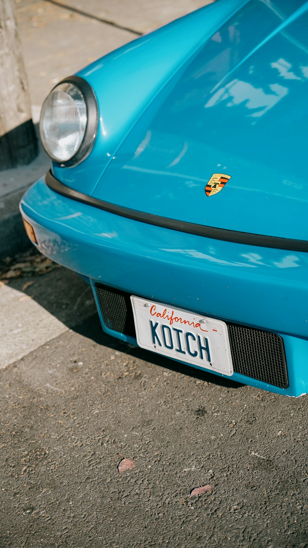 a close up of a blue car with a license plate