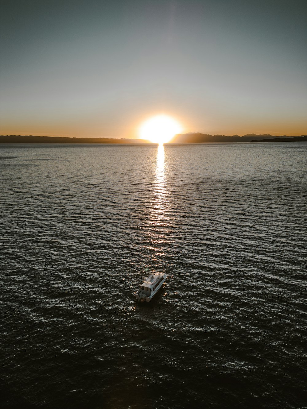a boat floating on top of a large body of water