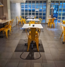 Cozy dining area of Easy Plates Restaurant with yellow and black decor reflecting the brand colors.