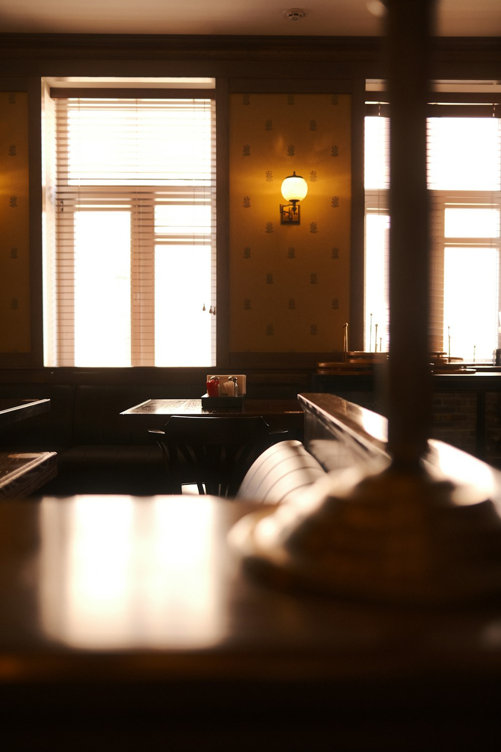 a dimly lit room with tables and benches