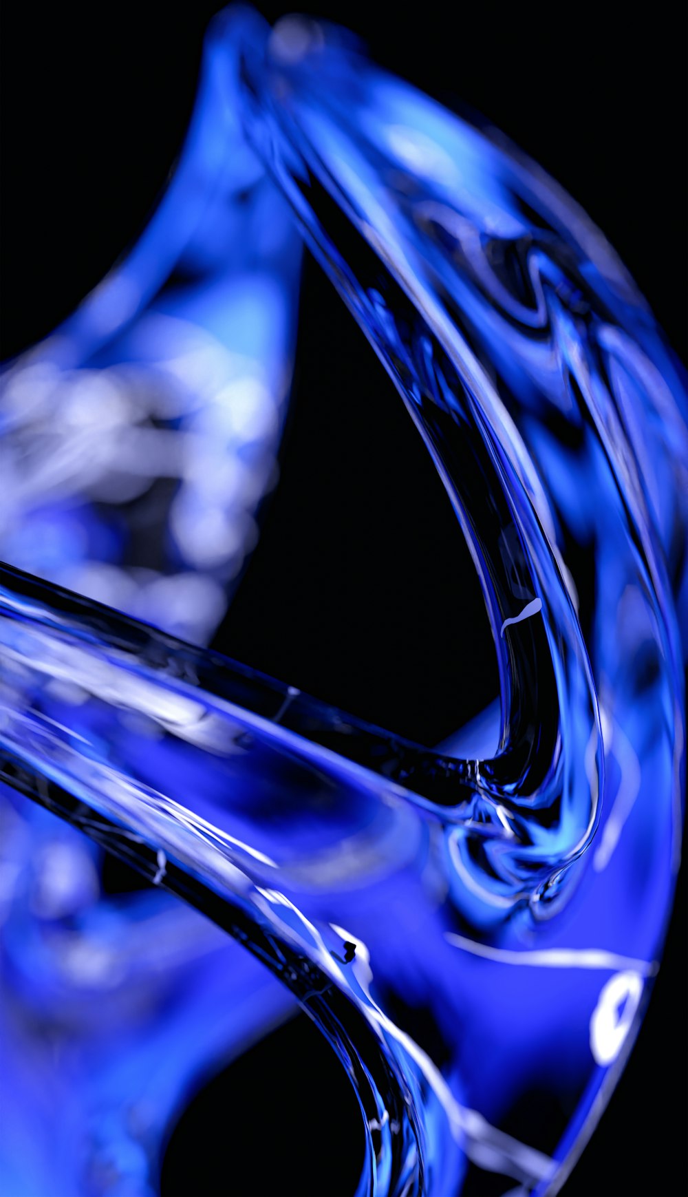 a blue glass vase sitting on top of a table