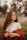 a woman with curly hair wearing a red cape