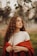 a woman with curly hair wearing a red cape