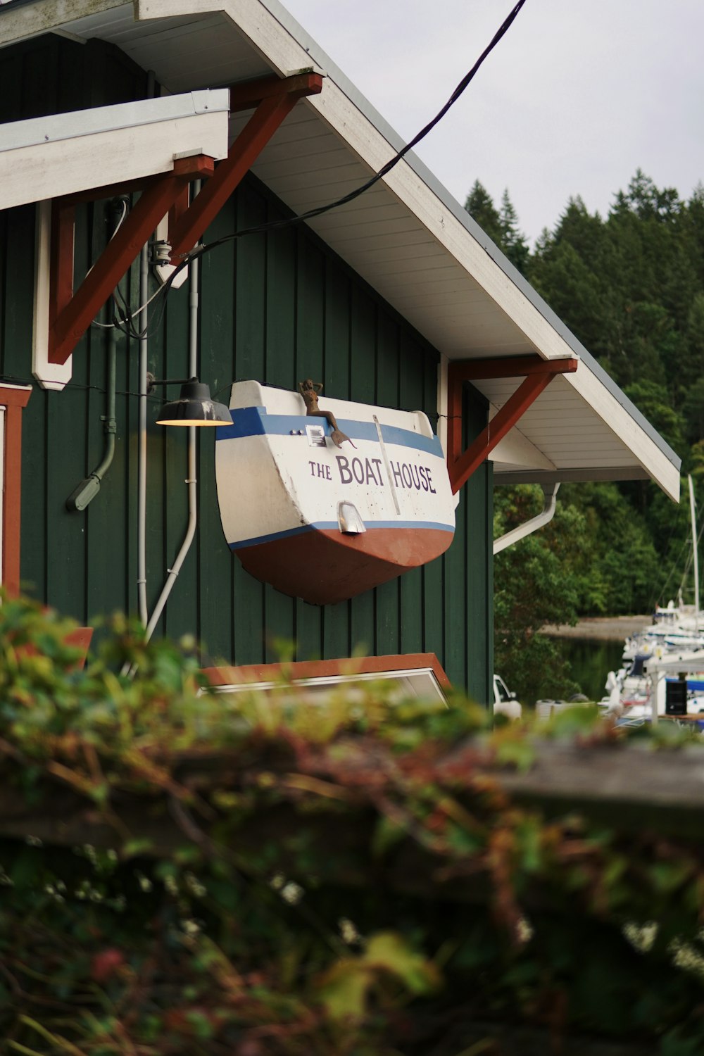 a boat hanging from the side of a green building