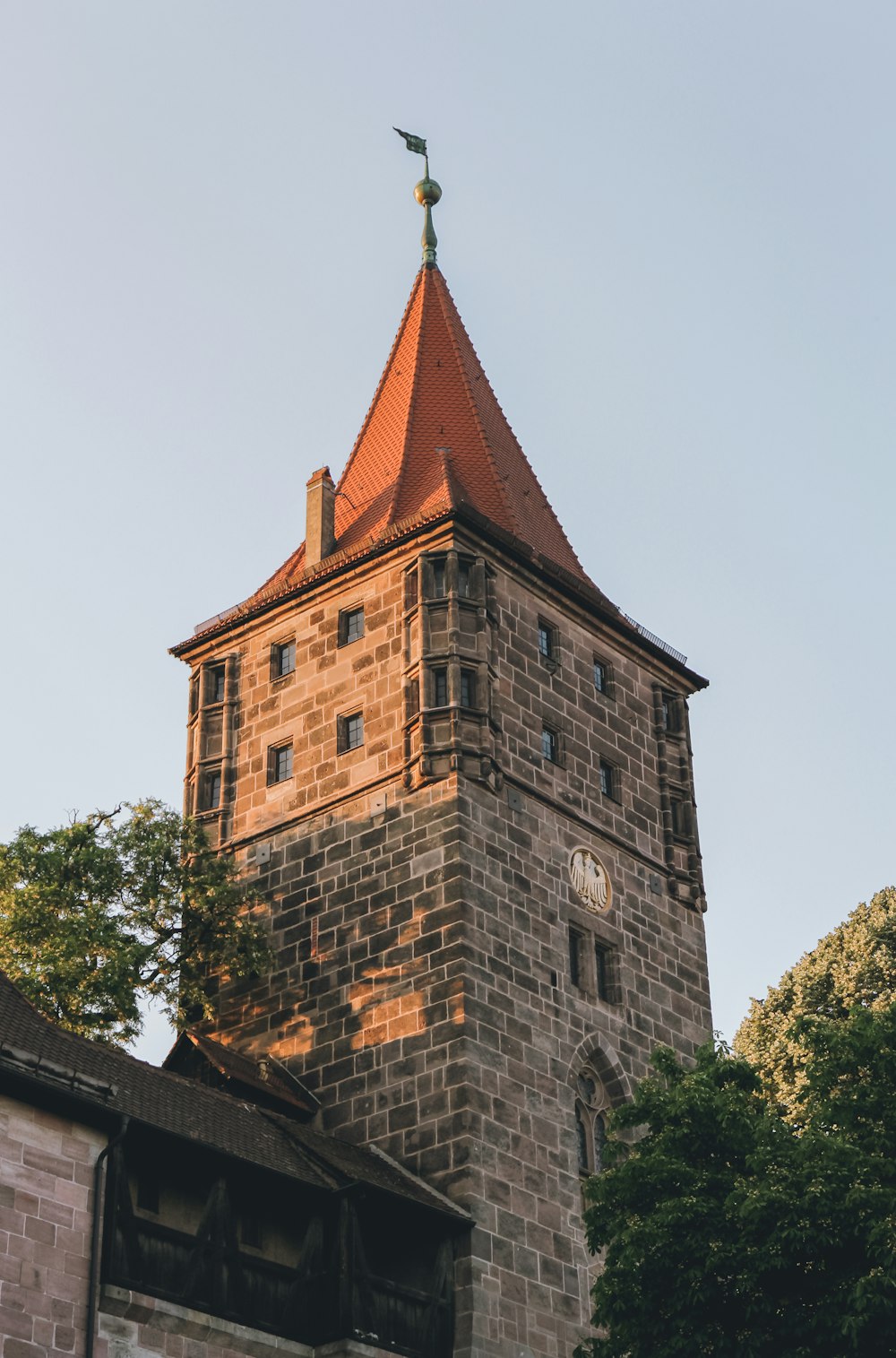 a tall brick tower with a clock on it's side