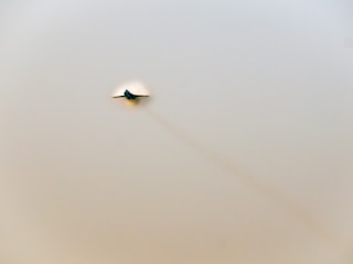 Fighter jet releasing a small satellite into the sky at high speed.
