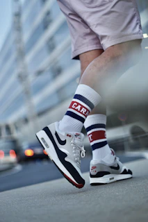 A casual street scene featuring someone wearing 43 d'etat trainers and socks, walking confidently down the city sidewalk.