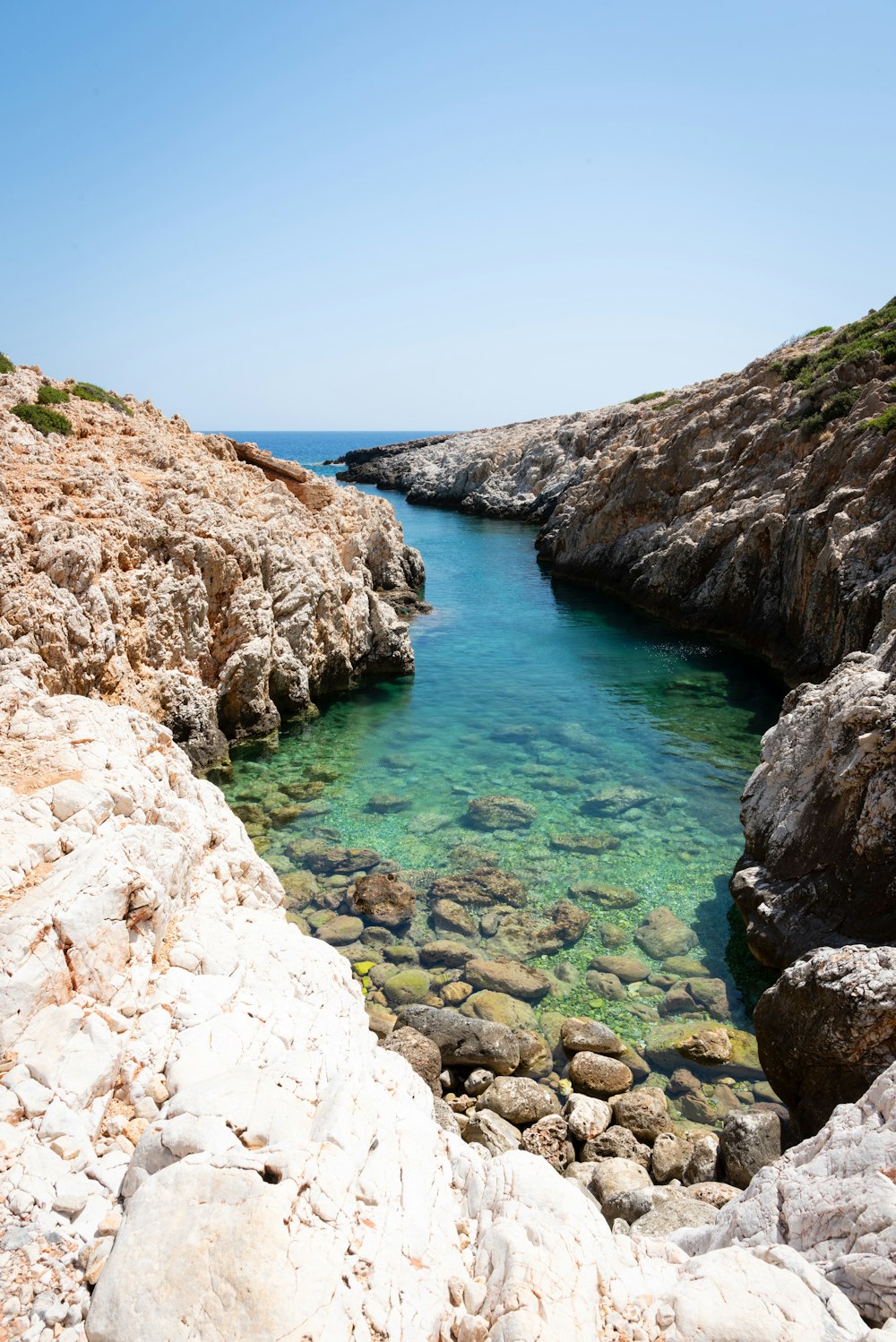 a body of water surrounded by rocky shoreline