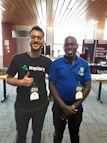 Dominics and Marys team smiling while holding custom printed t-shirts