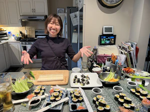 A warm kitchen scene with the Japanese chef preparing colorful sushi rolls.