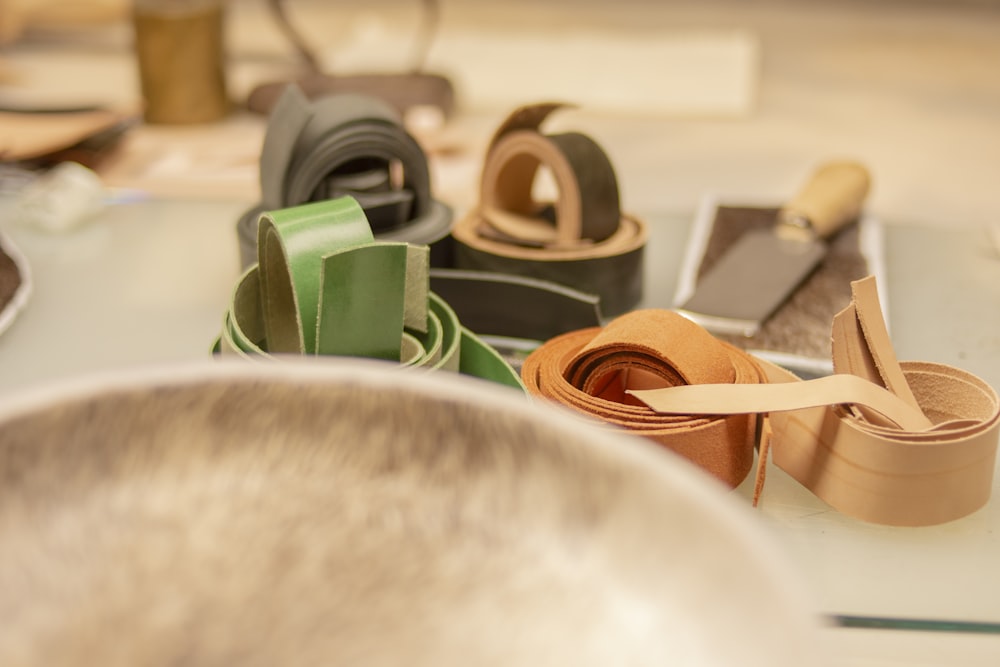 a table topped with lots of different types of belts