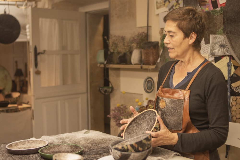 a woman in a kitchen holding a plate