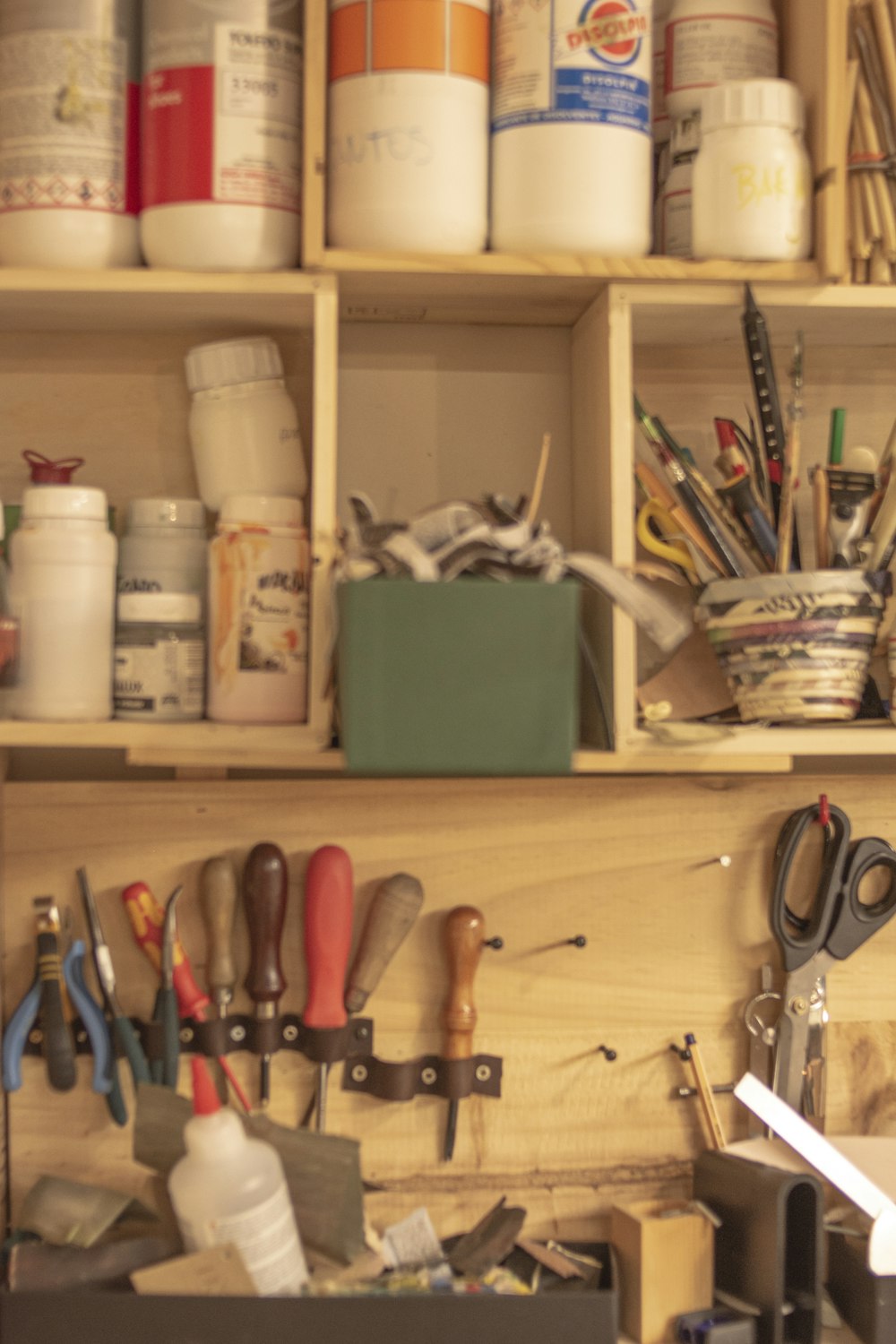 a wooden shelf filled with lots of craft supplies