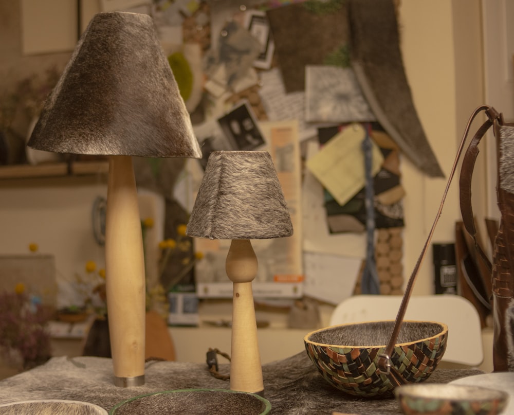 a table topped with a bowl and two lamps