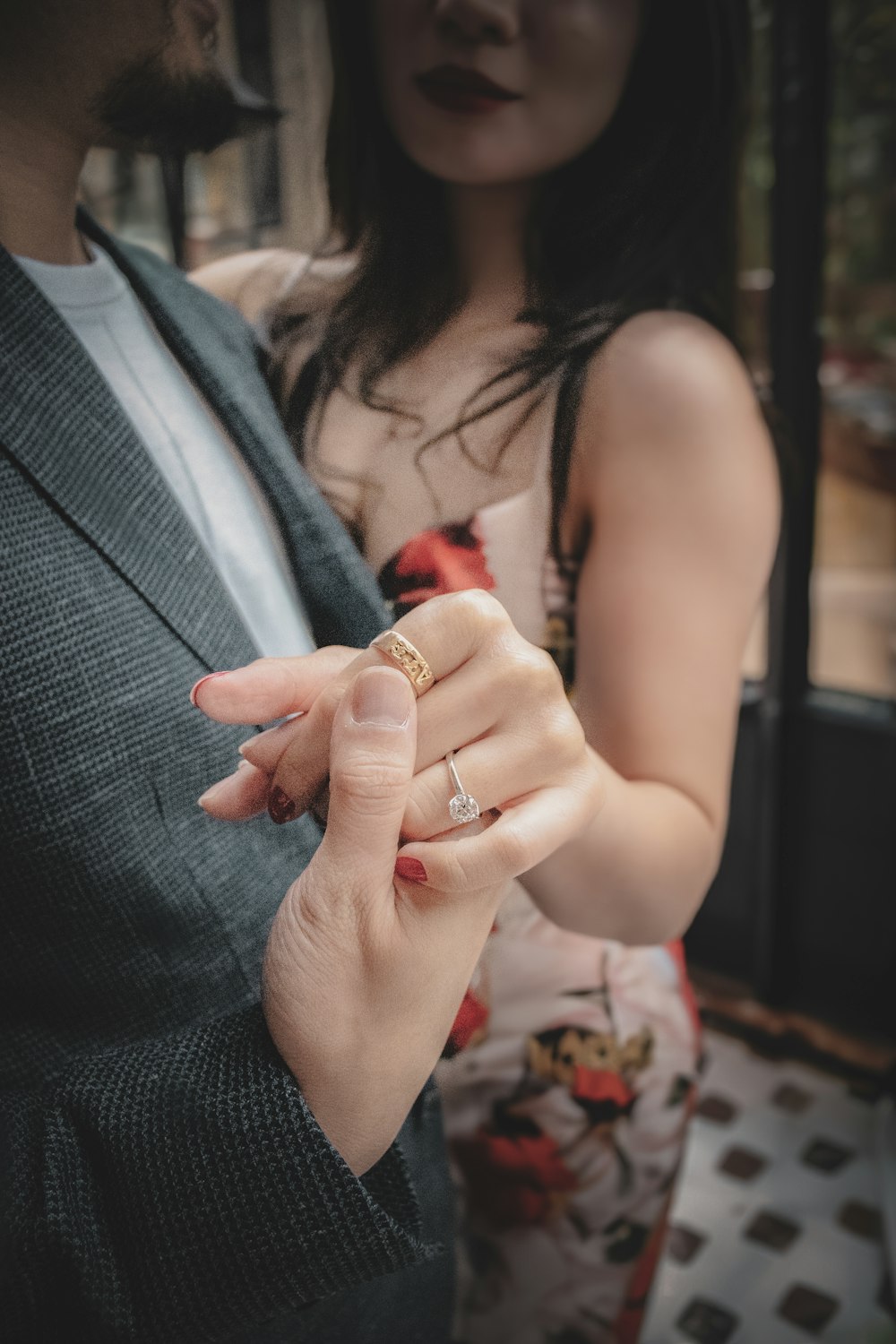 a man and a woman holding hands and looking at each other