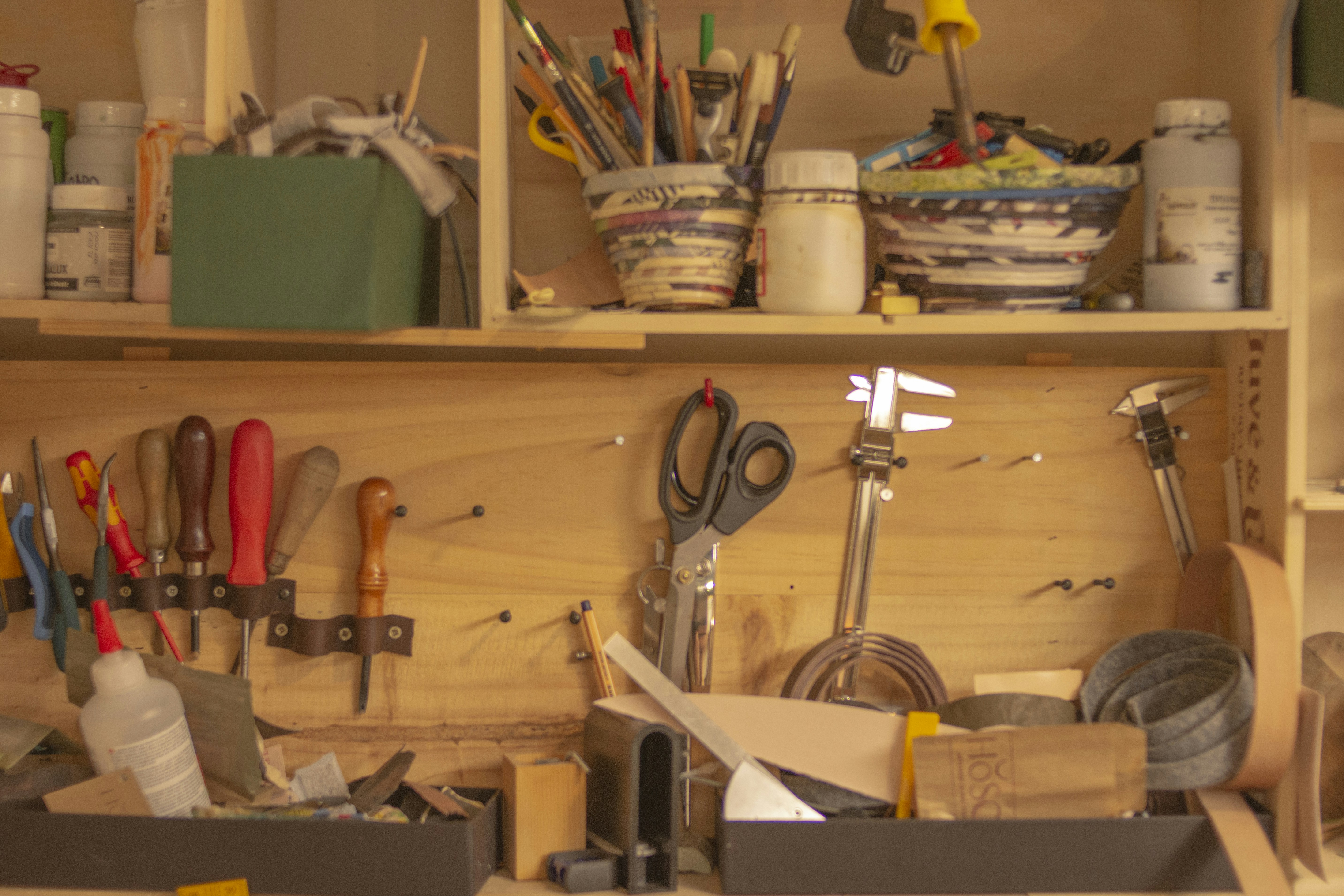 a wooden shelf filled with lots of tools