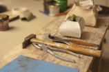 Crafting tools displayed on a wooden table.