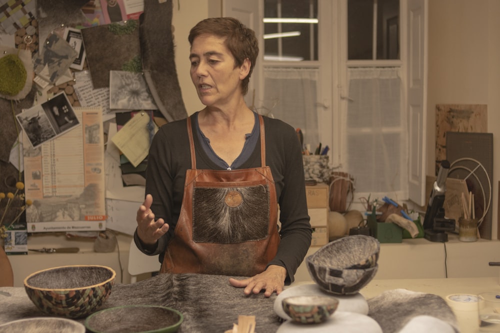 a woman wearing an apron standing in a kitchen