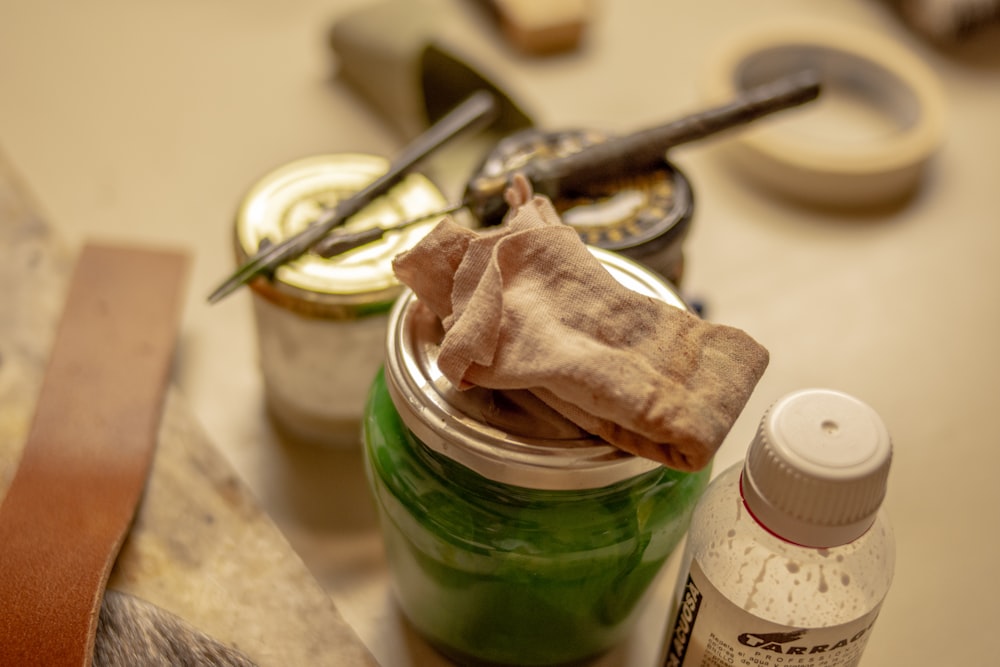 a jar of green stuff sitting on top of a table