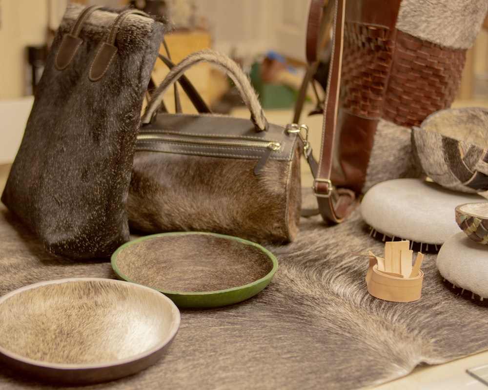 a table topped with lots of different types of purses